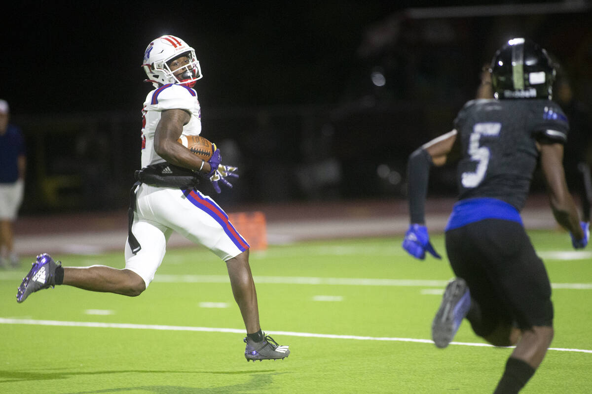 Liberty's Germie Bernard (2) eyes Desert Pines' Jaylen Allen (5) as he runs for a touchdown dur ...