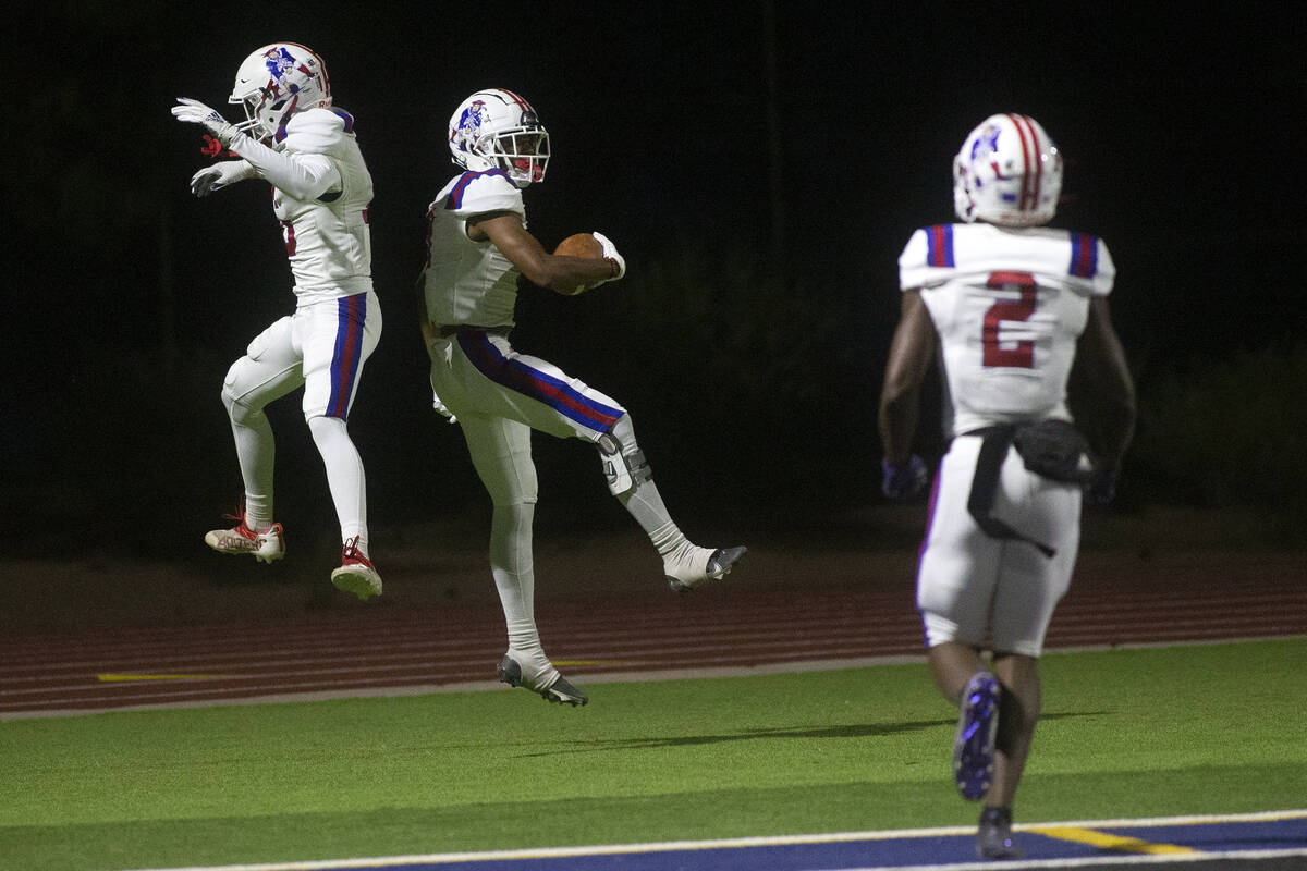 Liberty's Ethan Hilliard (16) and Marques Johnson (6) celebrate Marques' touchdown as their tea ...