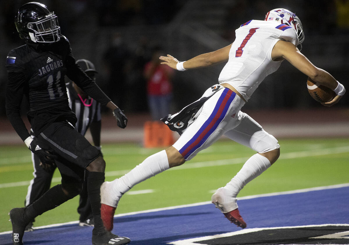 Liberty's Jayden Maiava (1) runs into the endzone for a touchdown as Desert Pines' Jaylin Morri ...