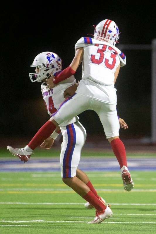 Liberty's Isaiah Hampton (24) and Ryden-james Dacosin (33) celebrate one of their team's touchd ...