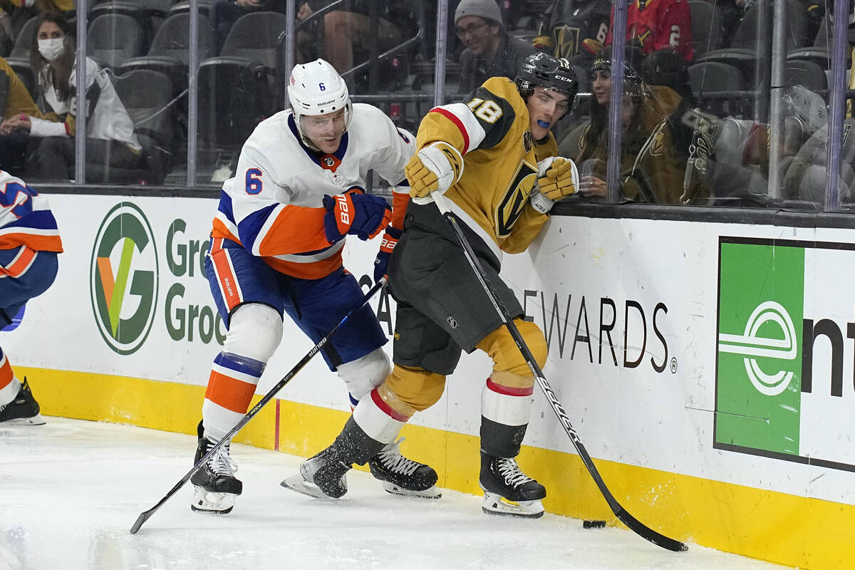 New York Islanders defenseman Ryan Pulock (6) and Vegas Golden Knights Peyton Krebs fight for t ...