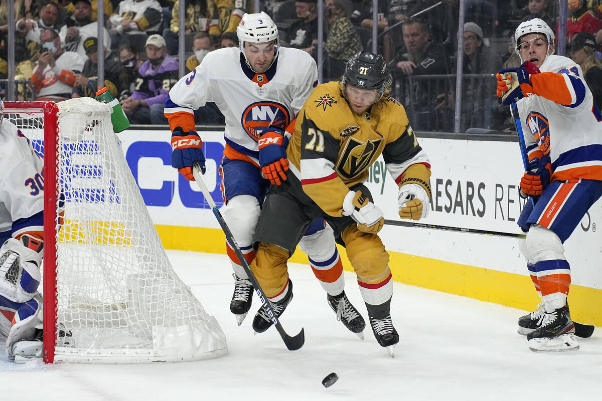 New York Islanders defenseman Adam Pelech (3) and Vegas Golden Knights William Karlsson battle ...