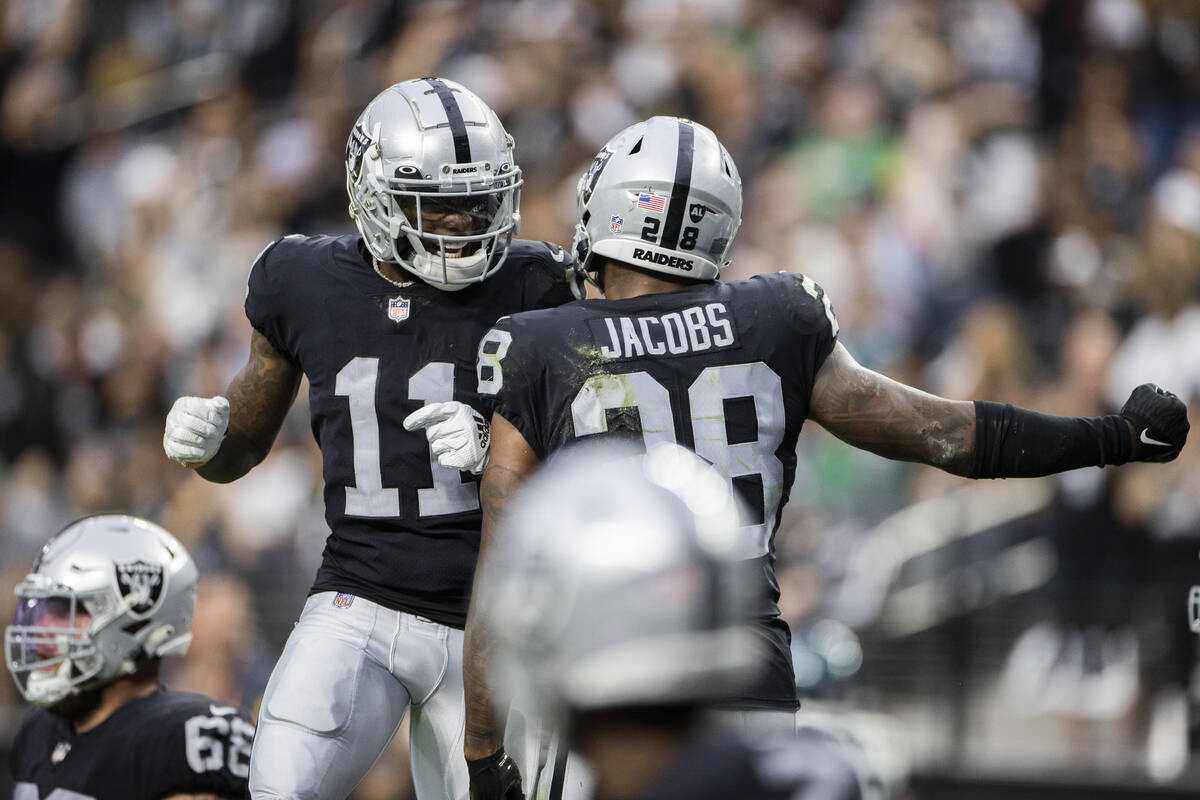 Raiders running back Josh Jacobs (28) celebrates a touchdown run with Raiders wide receiver Hen ...