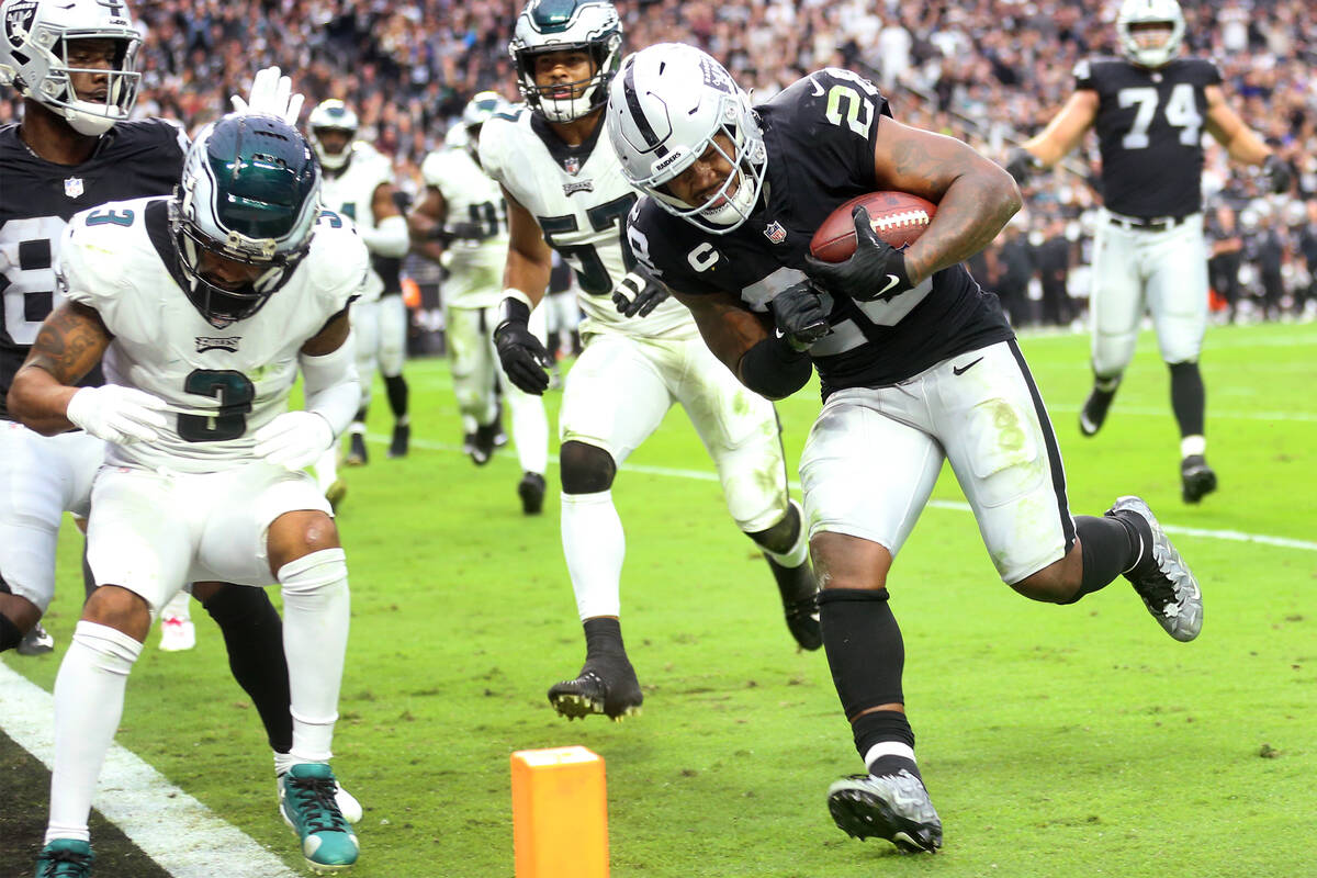 Raiders running back Josh Jacobs (28) runs the ball for a touchdown against the Philadelphia Ea ...