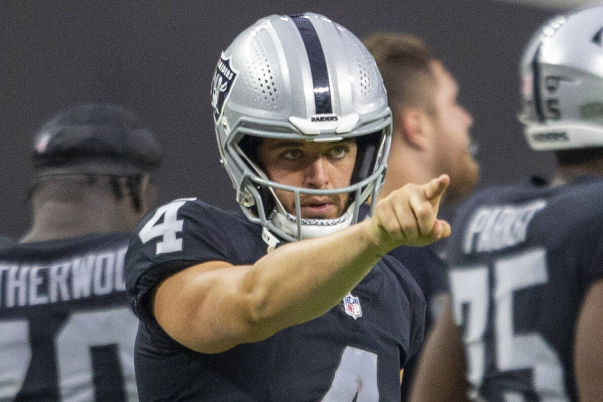 Raiders quarterback Derek Carr (4) points to Raiders wide receiver Henry Ruggs III (11), not pi ...