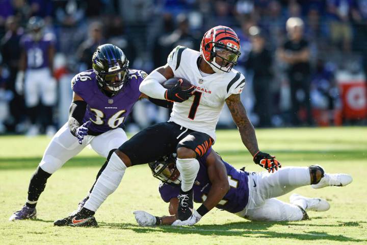 Baltimore Ravens safety Chuck Clark (36) and cornerback Marlon Humphrey (44) miss a tackle of C ...