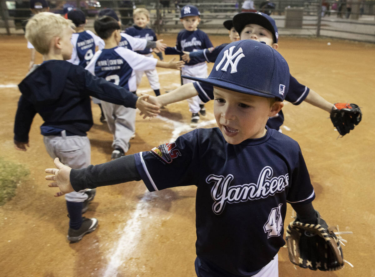 Yankees player Maddox Connell (41) shakes hands with Braves players at the end of their tee bal ...