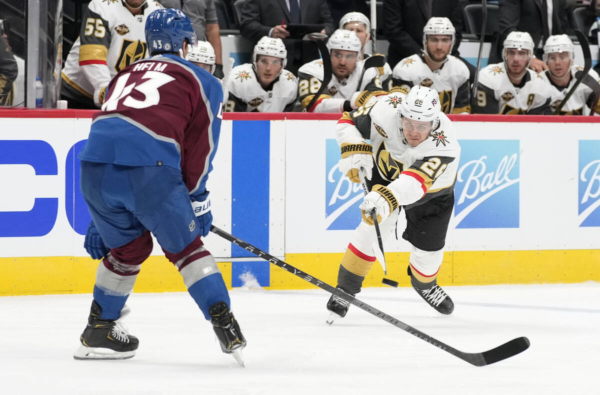 Vegas Golden Knights center Mattias Janmark, right, fires a shot past Colorado Avalanche left w ...