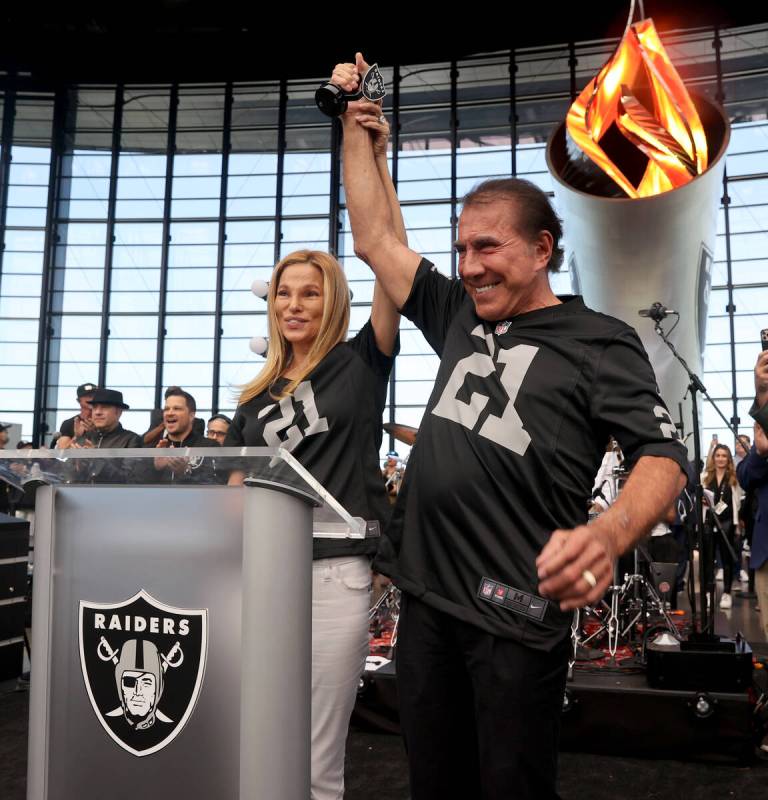 Steve Wynn lights the Al Davis Memorial Torch with his wife Andrea Hissom before the Raiders ta ...