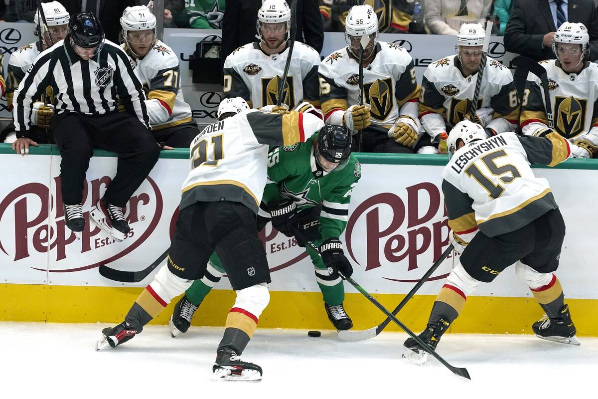 Vegas Golden Knights center Brett Howden (21) and center Jake Leschyshyn (15) attempt to gain c ...