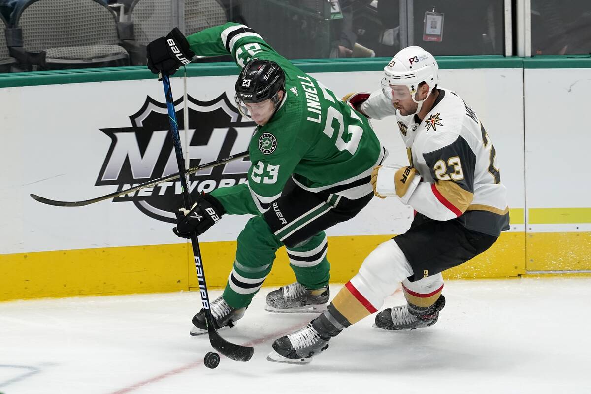 Dallas Stars defenseman Esa Lindell, left, controls the puck under pressure from Vegas Golden K ...