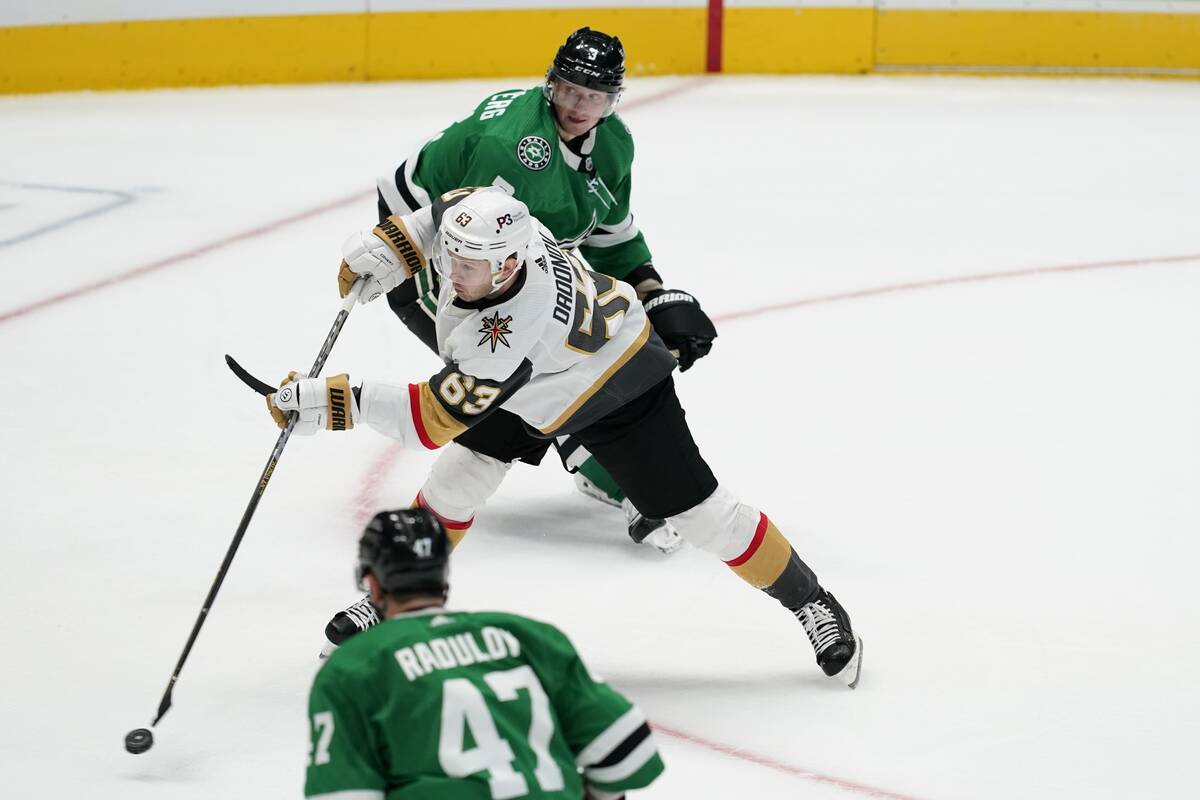 Vegas Golden Knights right wing Evgenii Dadonov (63) shoots a goal between Dallas Stars' Alexan ...