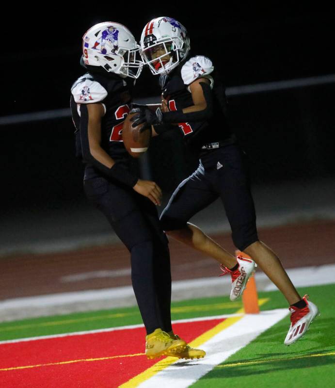 Liberty High School's Isaiah Hampton (14) celebrates his touchdown with Liberty High School's A ...