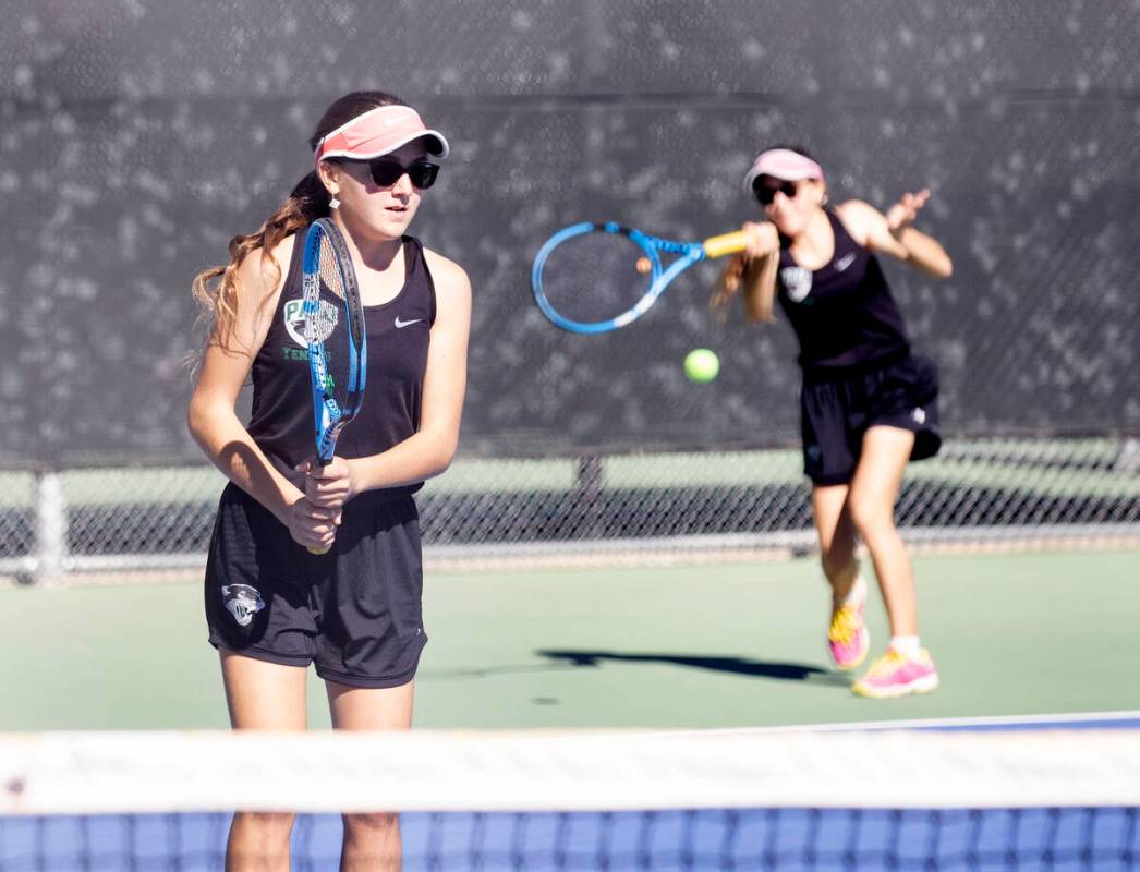 Palo HighÕs Sabrina Novruzova returns the ball as her twin sister Zarina, left, looks on d ...