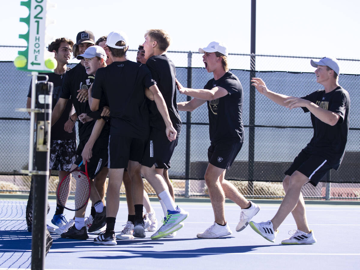 Faith LutheranÕs Nolan Dubay, left, stormed by his teammates after beating Palo HighÕ ...