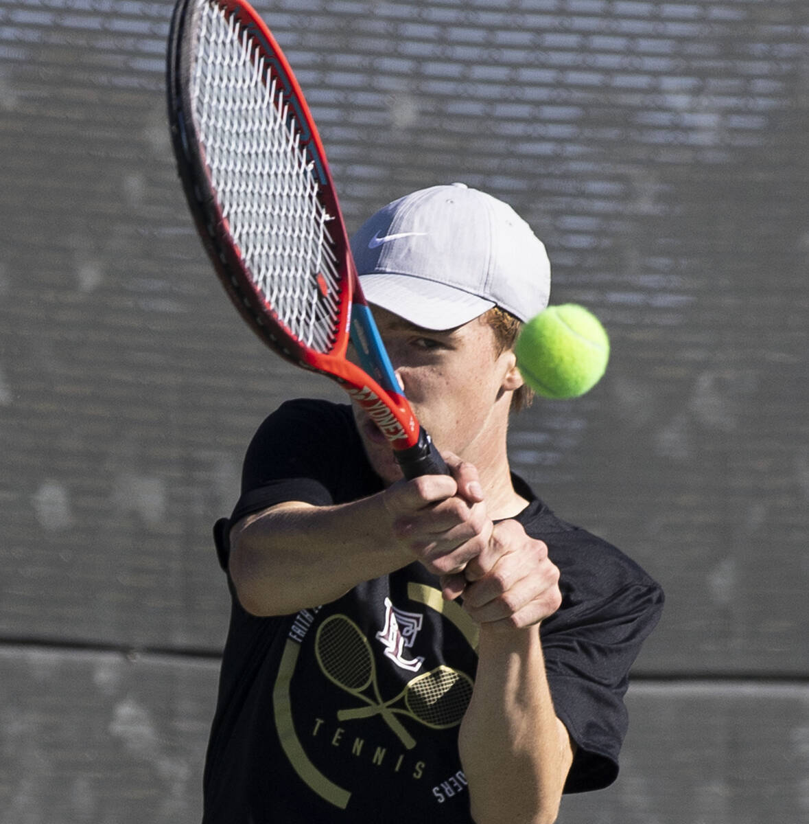 Faith LutheranÕs Nolan Dubay returns the ball against Palo HighÕs Jonas Santos during ...