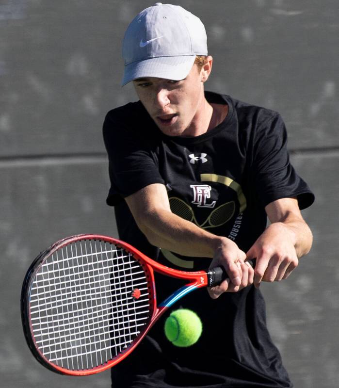 Faith LutheranÕs Nolan Dubay returns the ball against Palo HighÕs Jonas Santos during ...