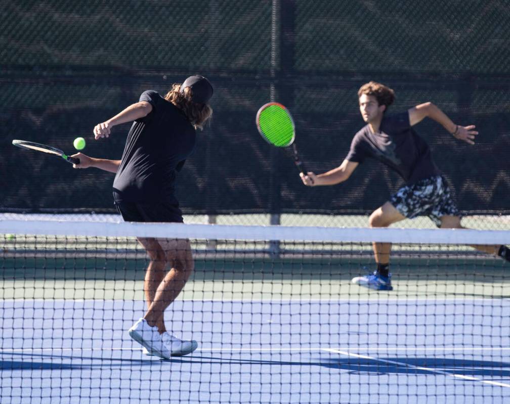 Faith Lutheran’s Nicco Ripamonti, left, and Steven Dobrev try to return the ball during ...