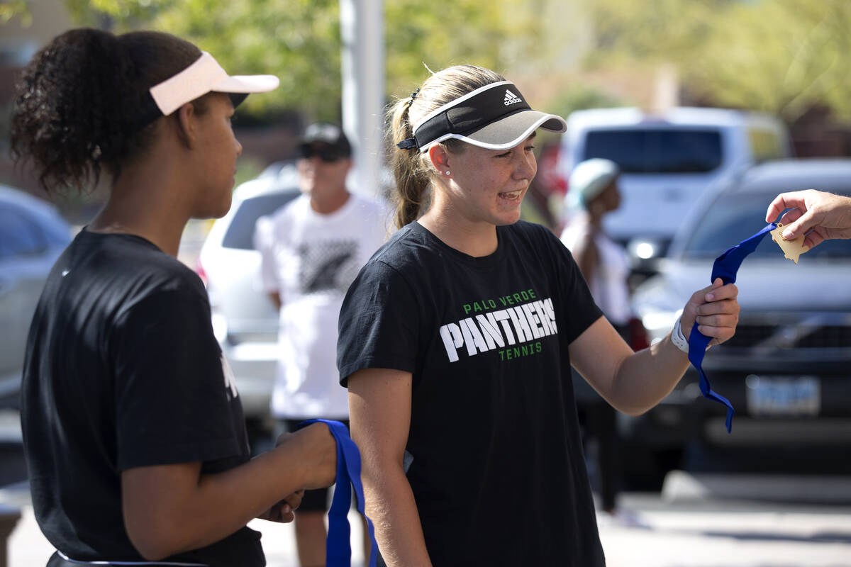 Palo Verde's Cambell Ricci accepts a state title medal alongside Paisha Douglas for winning the ...