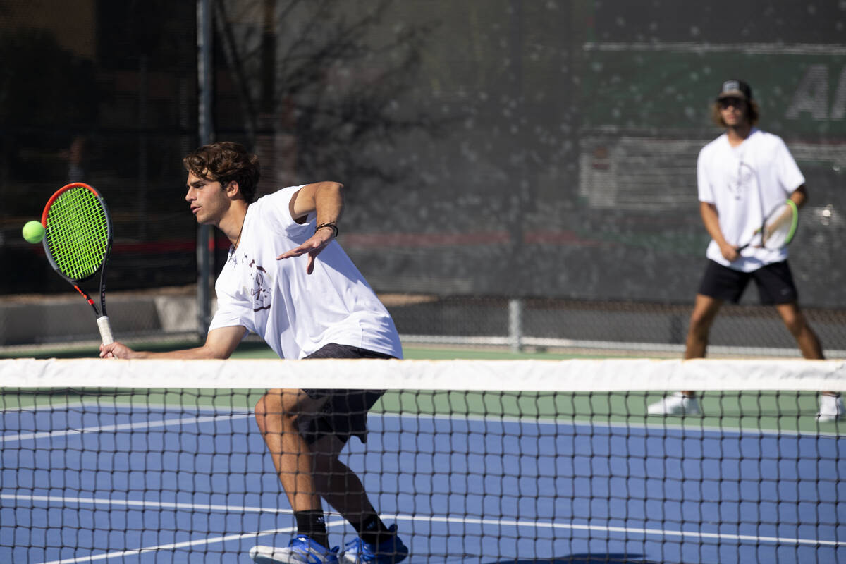 Faith Lutheran's Stephen Dobrev hits to Reno while playing a boys doubles match with Nicco Ripa ...