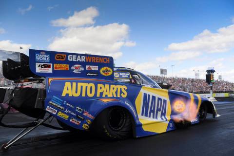 In this photo provided by the NHRA, Funny Car's Ron Capps drives to the win in the final round ...