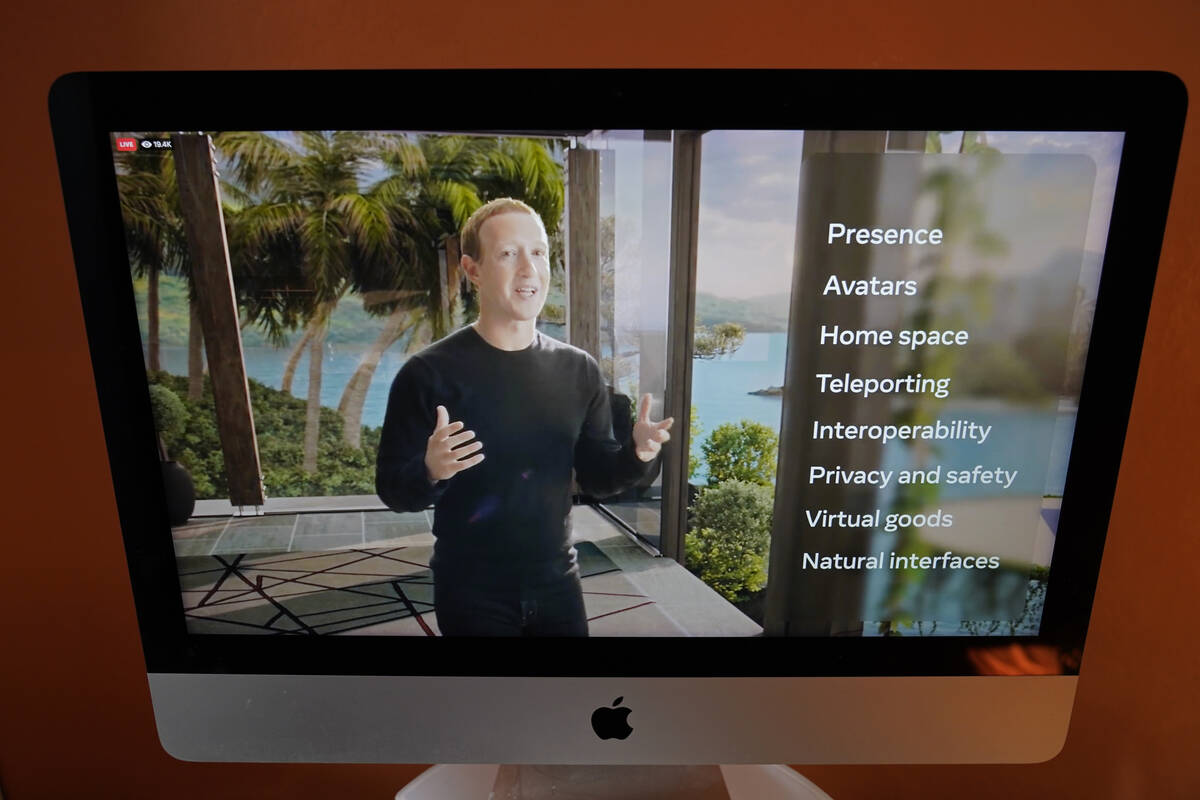 Seen on the screen of a device in Sausalito, Calif., Facebook CEO Mark Zuckerberg delivers the ...