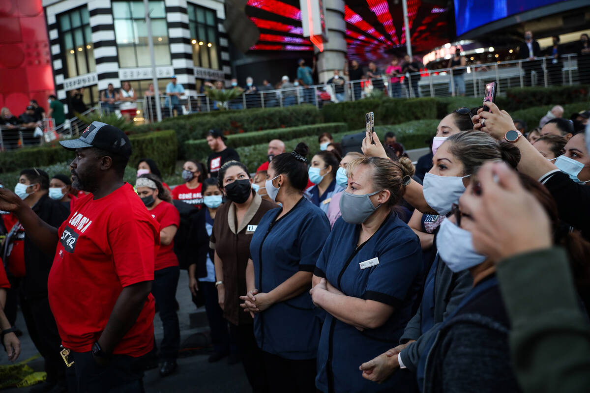 Attendees listen to the band Skanky Banks at a rally of the Culinary Workers Union to bring att ...