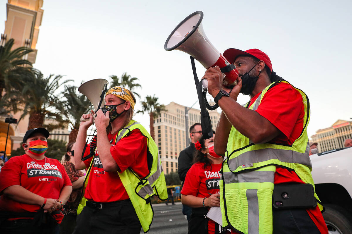 Chad Neanover, left, and James Reed, right, both organizers, cheer on the crowd at a rally of t ...