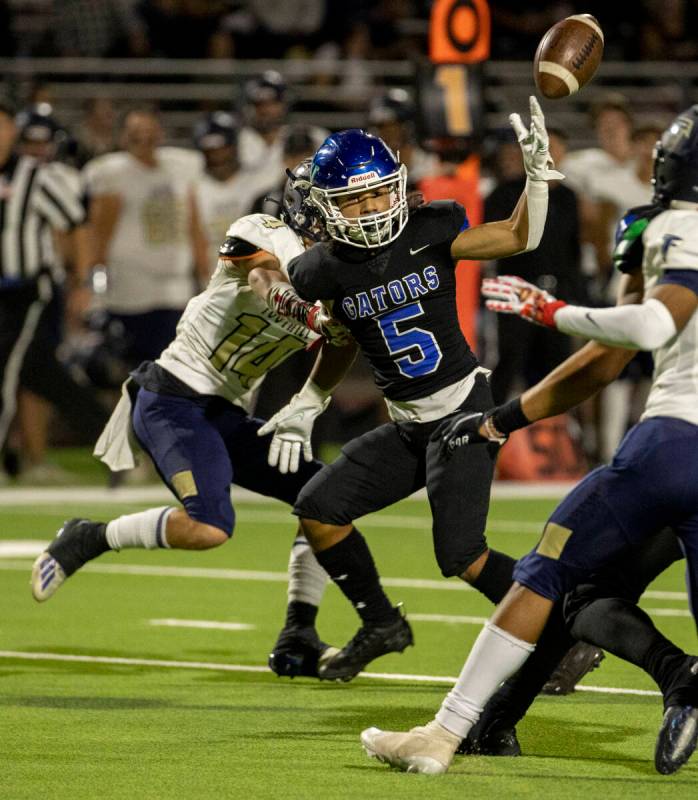 Green Valley receiver Freddy Rodriguez (5) has a pass deflected as Foothill safety Mason Kenzev ...