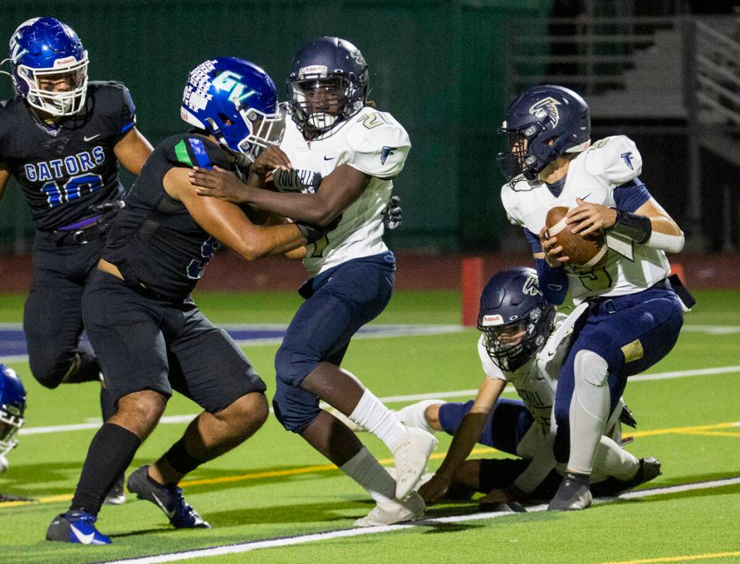 Foothill place holder LJ Wallick (3) picks up he ball and will throw a pass to a teammate for a ...