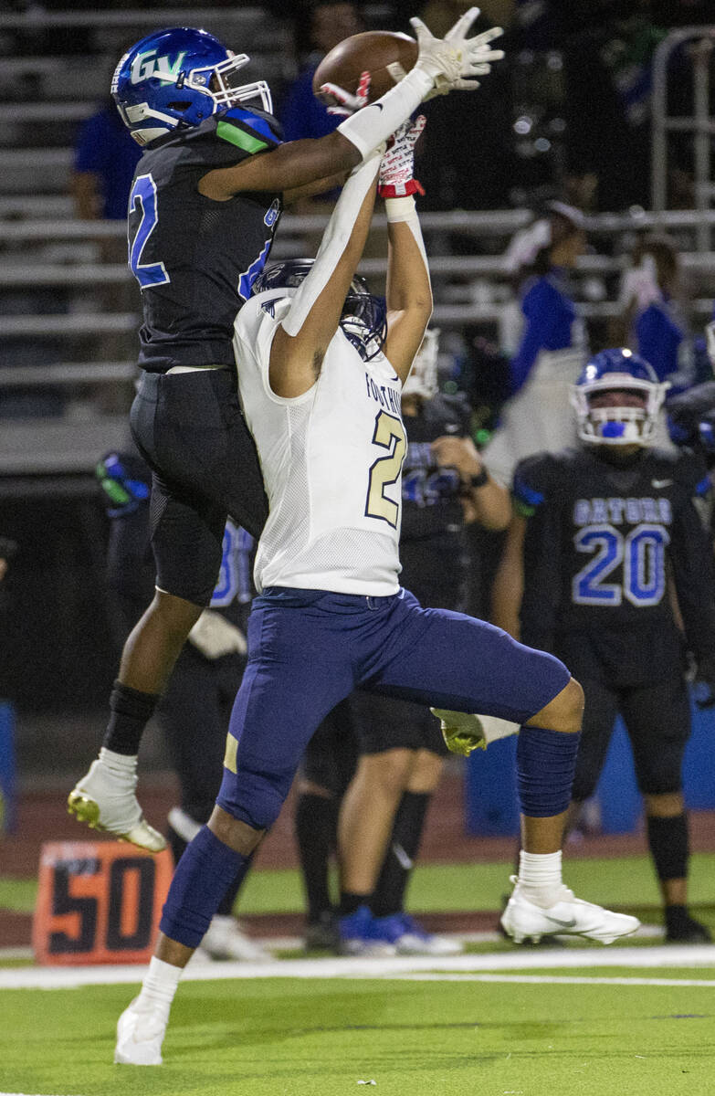 Green Valley receiver Justyn Delzeit (12) has a pass broken up by Foothill cornerback Christoph ...