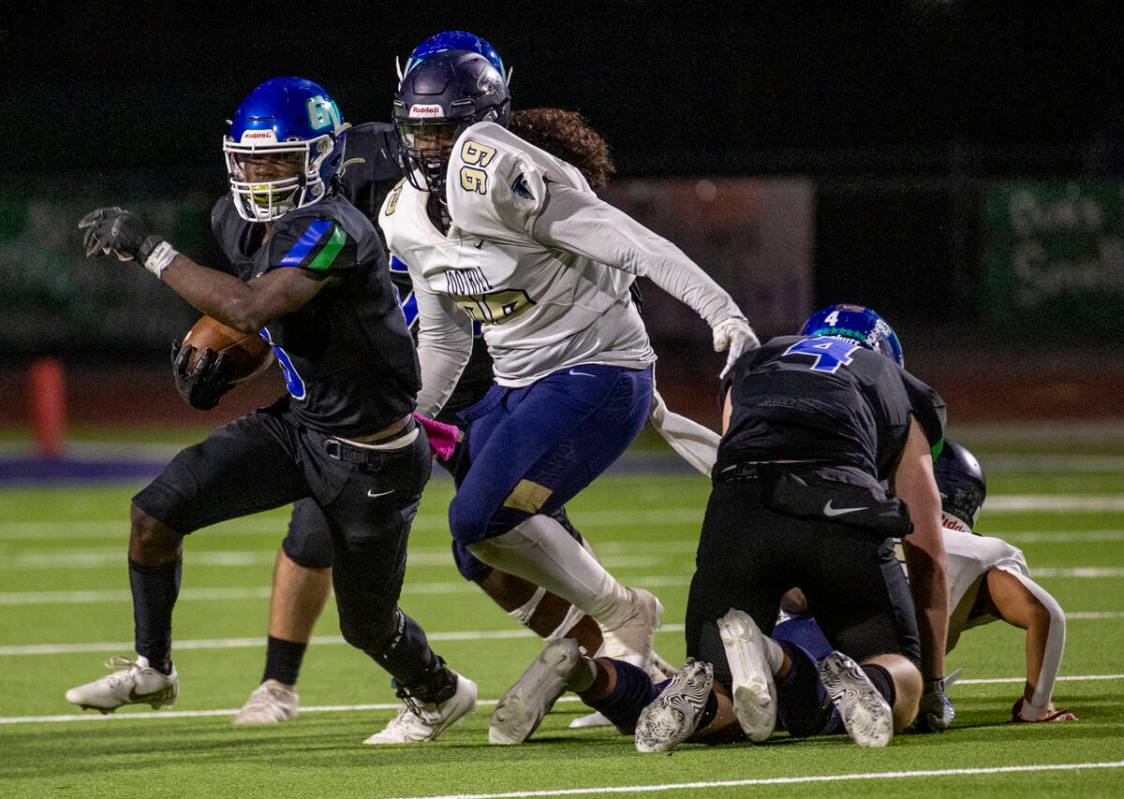 Green Valley running back Jaylen Mcknight (6) runs past Foothill defensive end Zarias Rose (99) ...