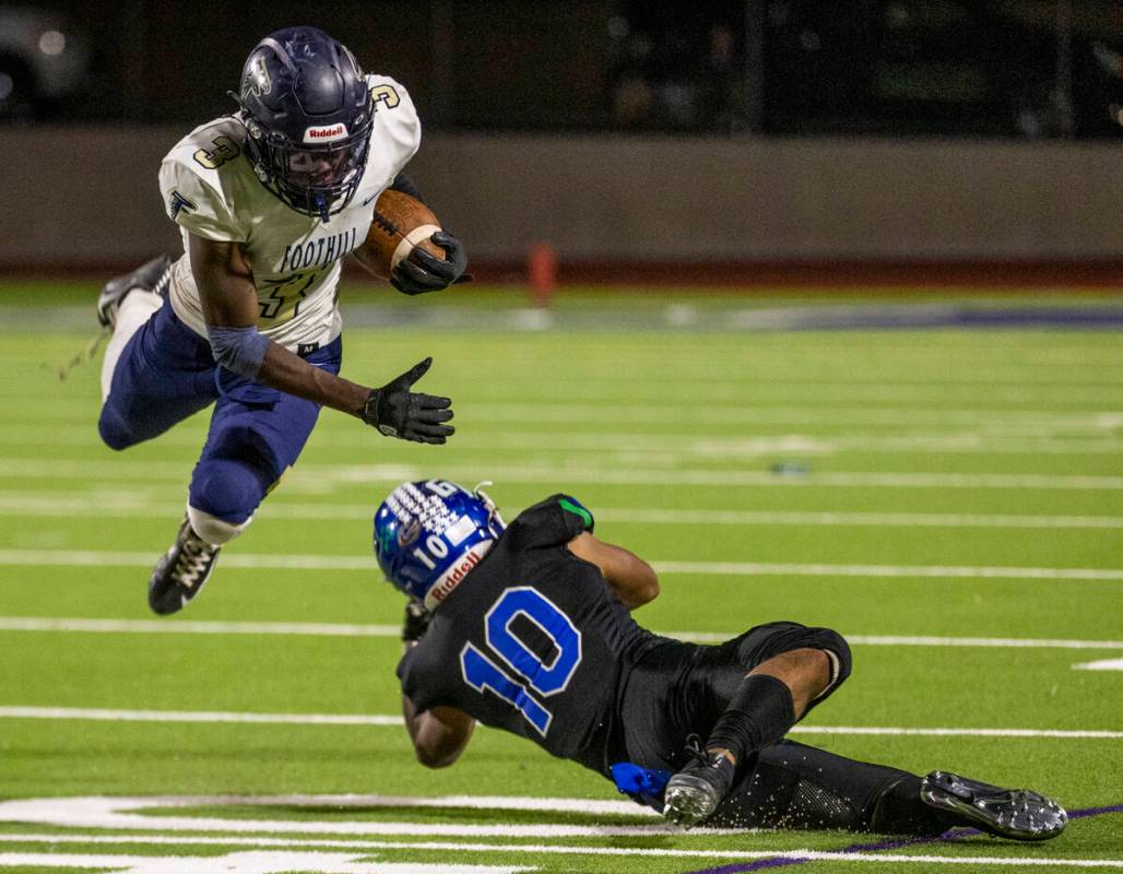 Foothill running back Kendric Thomas (3) is taken off his feet by Green Valley linebacker Sonny ...