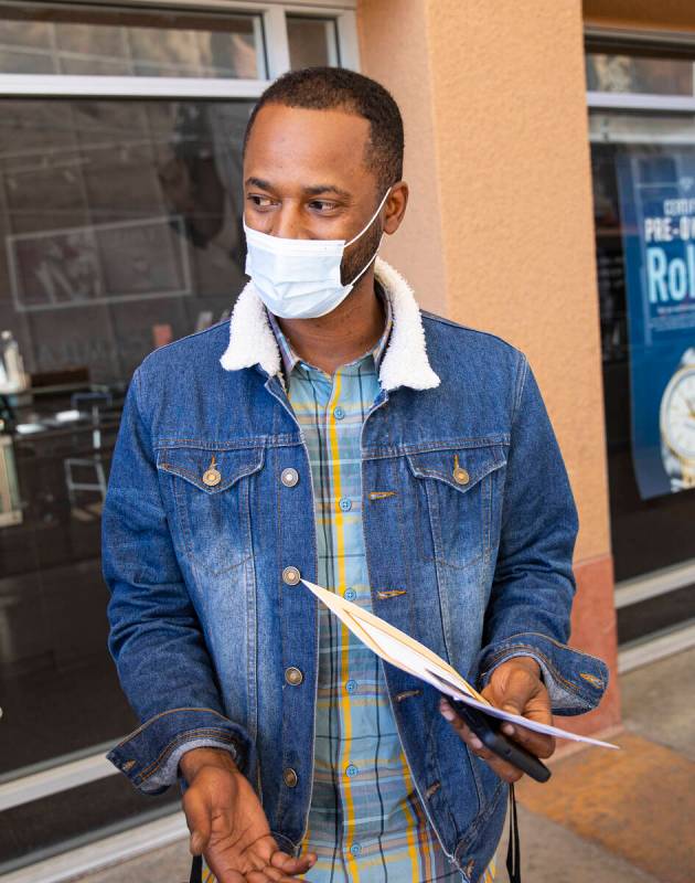 Sergio Pinto, of Las Vegas, talks about looking for a second job during a hiring fair at the La ...