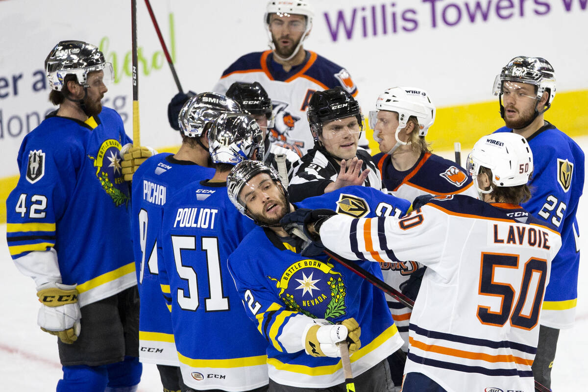 A referee breaks up a fight between players including Henderson Silver Knights forward Gage Qui ...