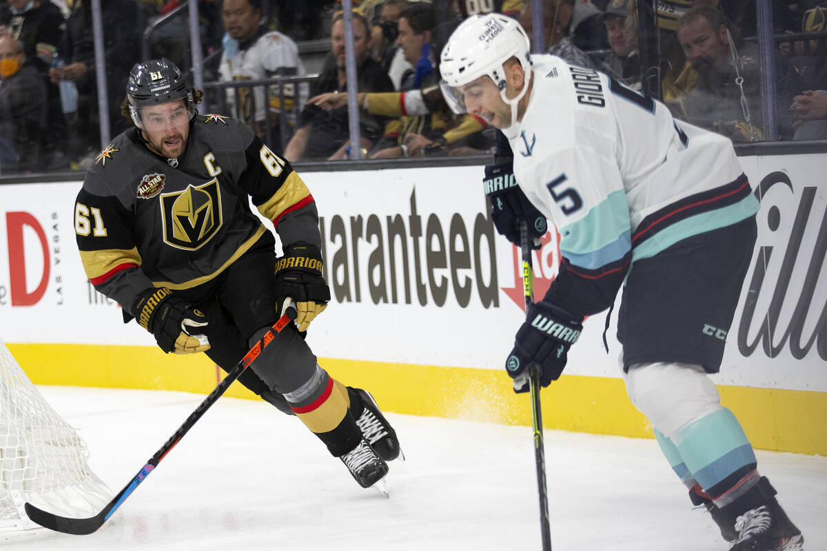 Golden Knights right wing Mark Stone (61) eyes the puck while Kraken defenseman Mark Giordano ( ...