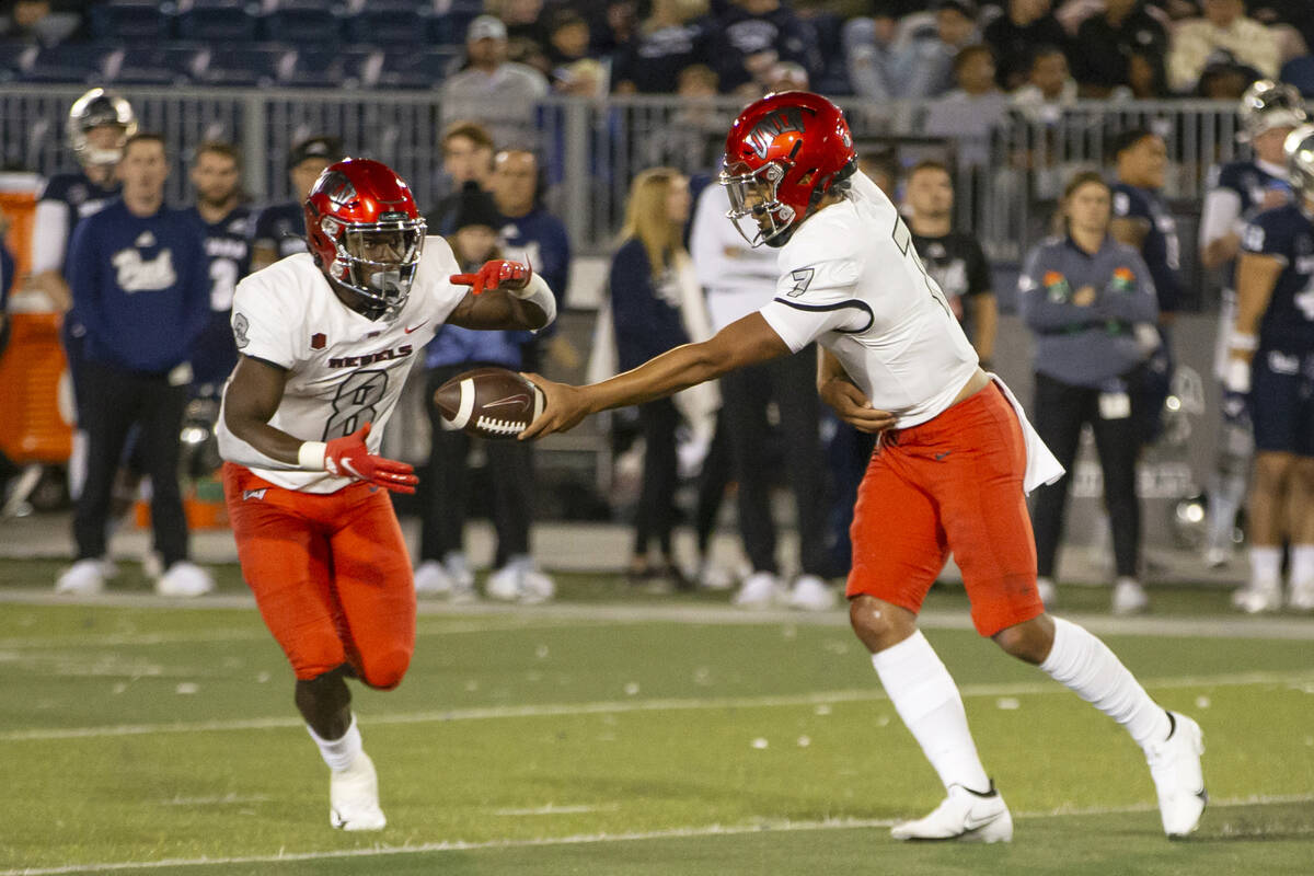 UNLV quarterback Cameron Friel (7) hands the ball off to running back Charles Williams (8) agai ...