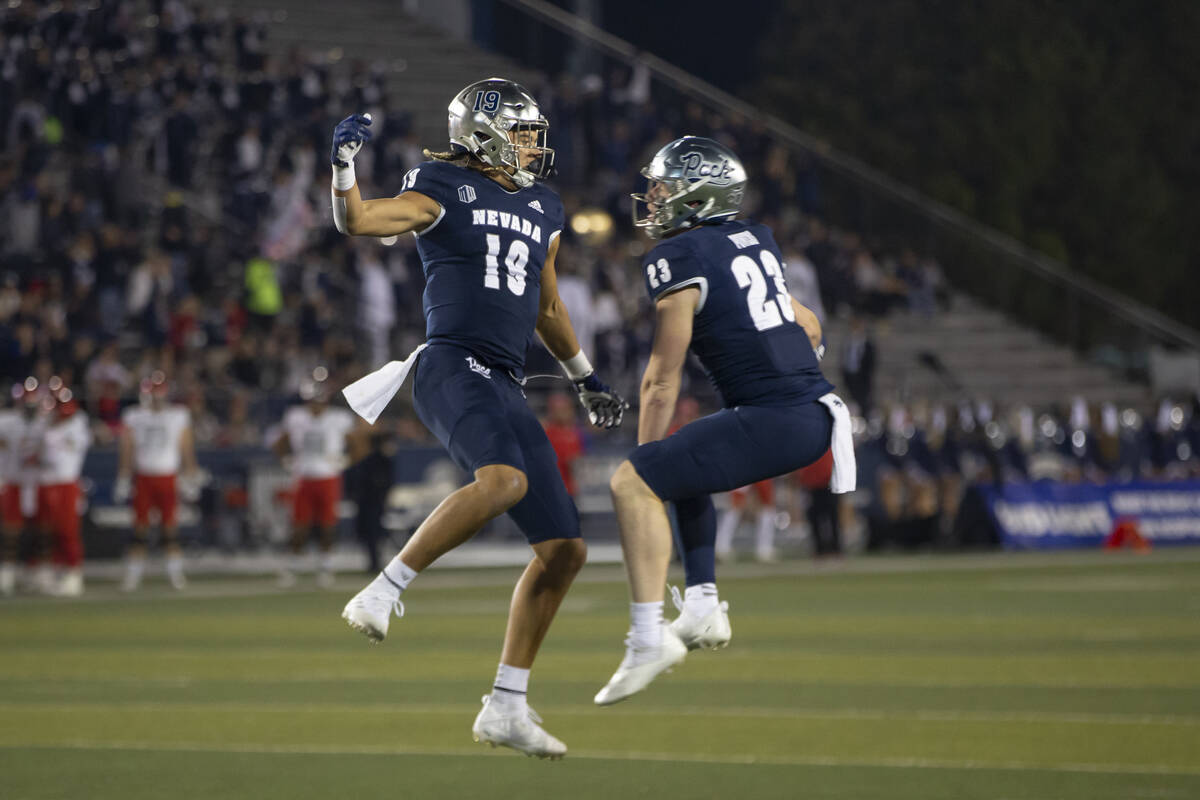 Nevada's Cole Turner (19) and Jacques Badolato-Birdsell (23) celebrate after a touchdown agains ...