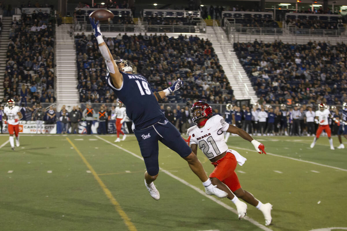 Nevada tight end Cole Turner (19) makes the one handed catch for a touchdown over UNLV defensiv ...