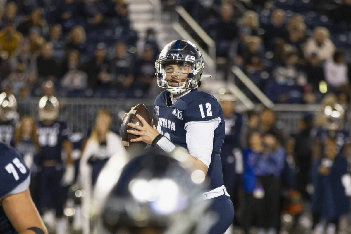 Nevada quarterback Carson Strong (12) looks to throw against UNLV in the first half of an NCAA ...