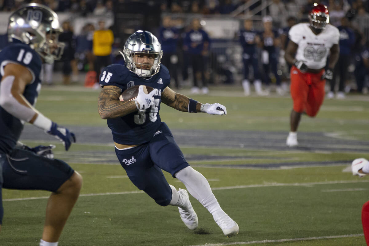 Nevada running back Toa Taua (35) carries against UNLV during the first half of an NCAA college ...