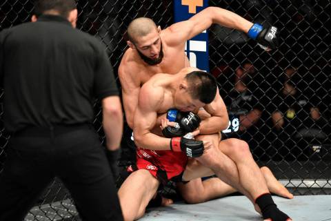 Khamzat Chimaev of Sweden punches Li Jingliang of China in a welterweight fight during the UFC ...