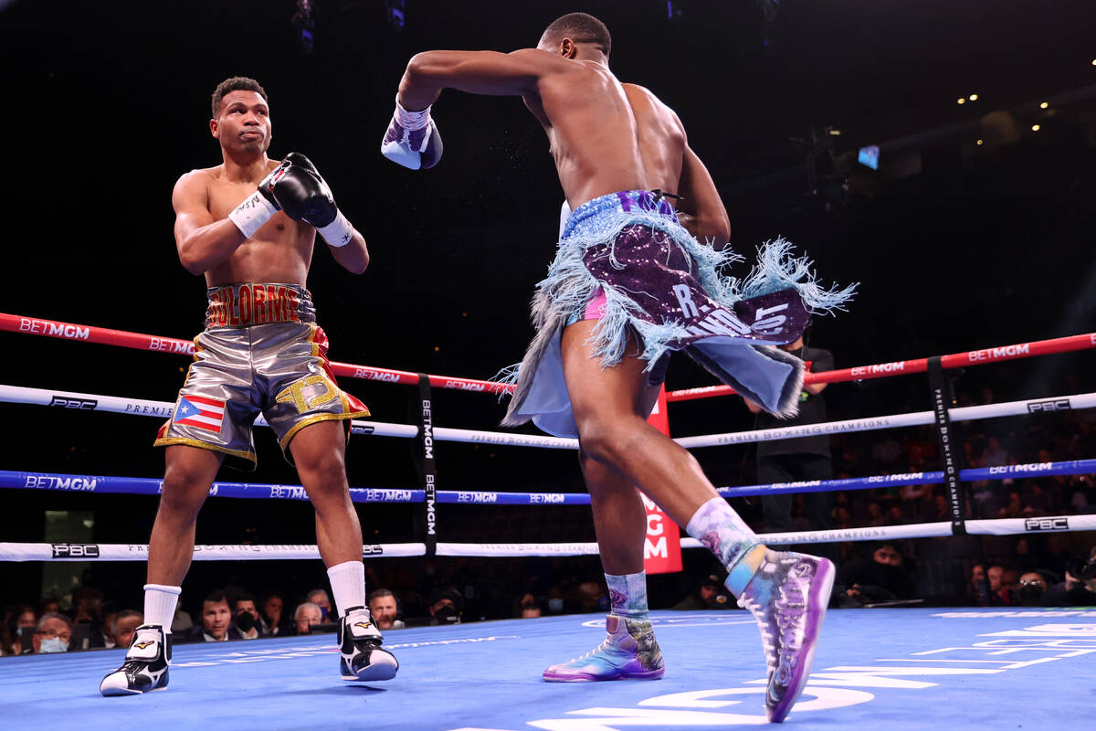 Jaron Ennis, right, connects a punch to knock down Thomas Dulorme in the first round of a welte ...