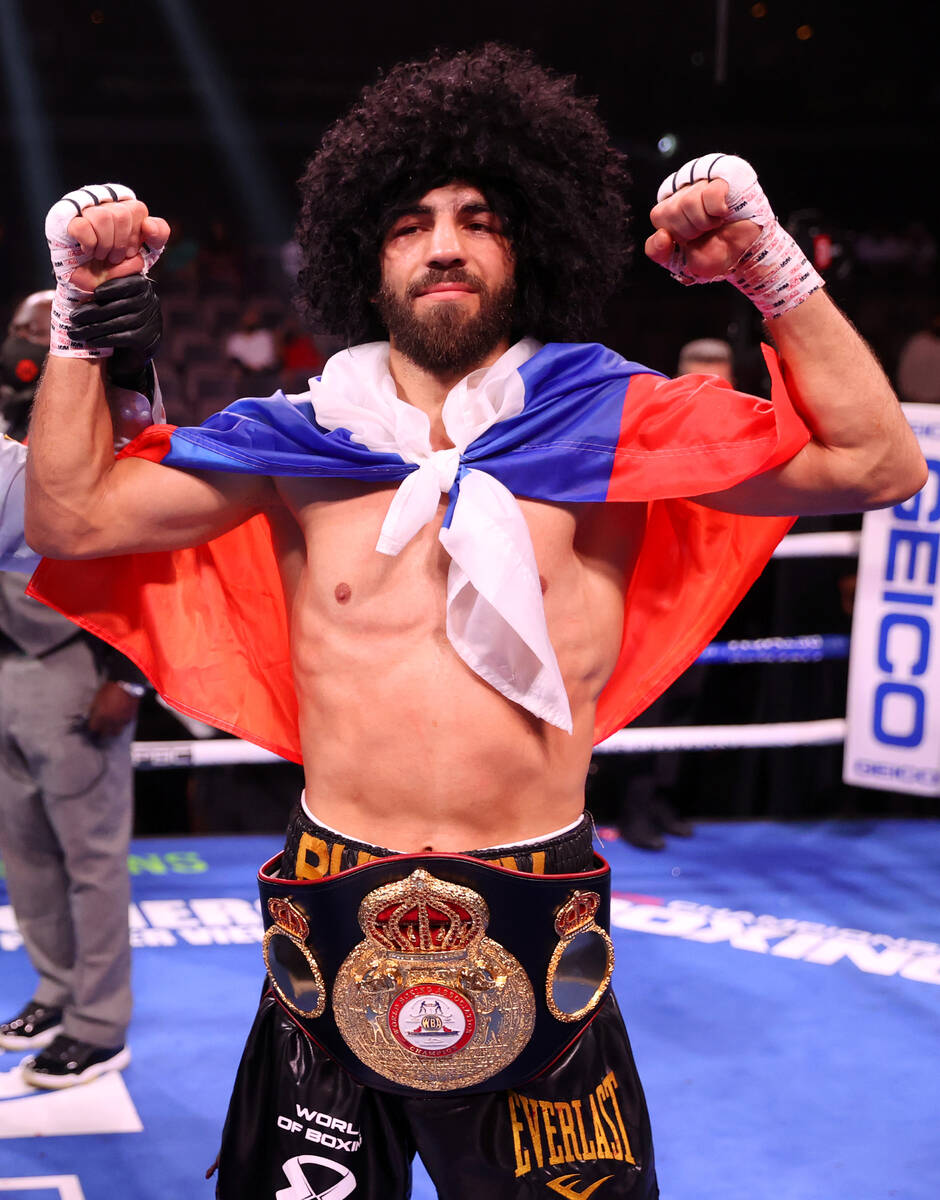 Radzhab Butaev raises his hands in victory after his technical knockout win against Jamal James ...