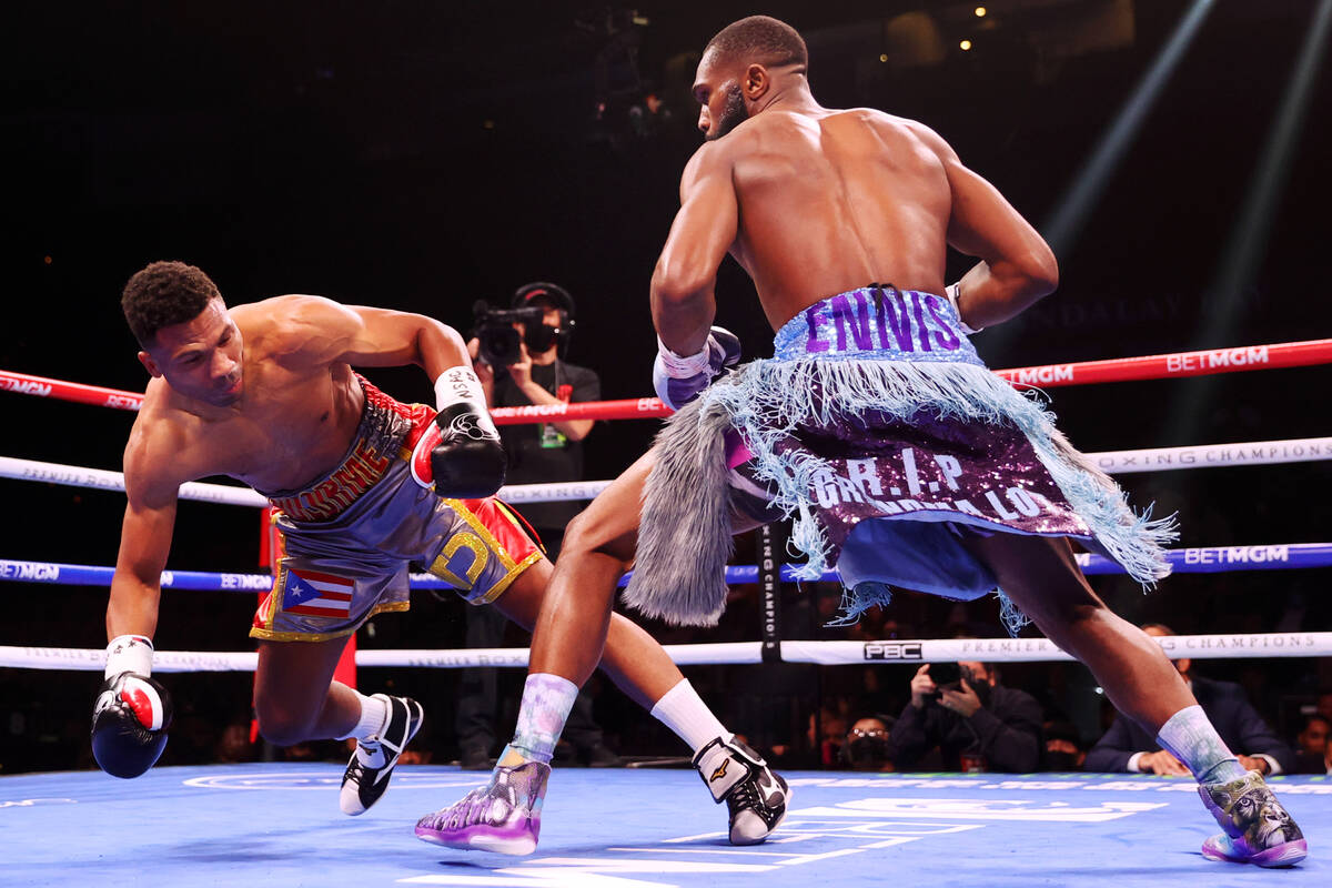 Jaron Ennis, right, knocks down Thomas Dulorme in the first round of a welterweight bout at Mic ...