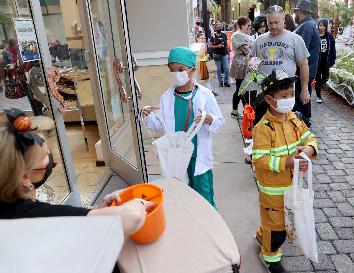 Rian, 9, and Rylee Deguzman, 6, of Henderson during the Halloween Ghost Walk at The District at ...