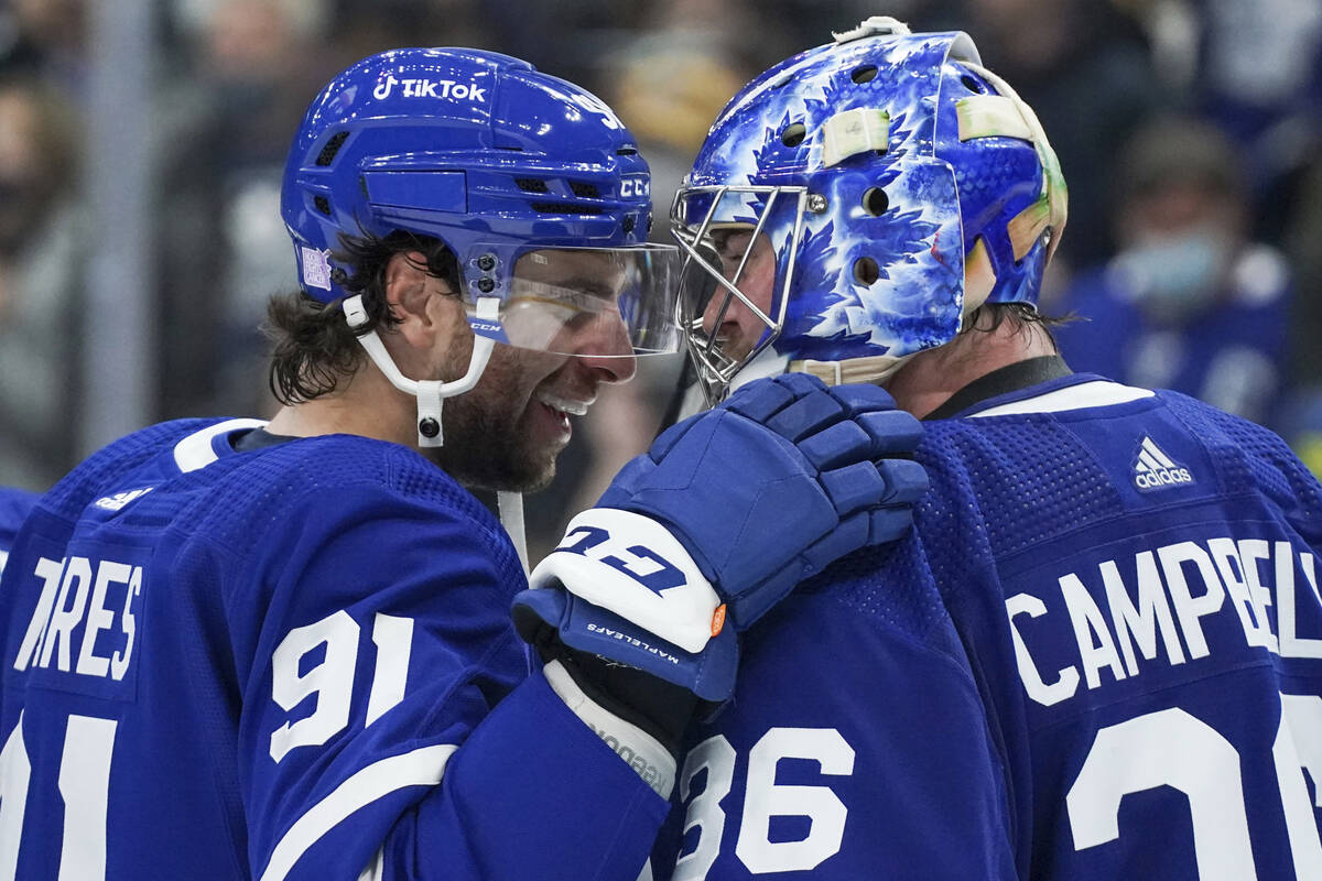 Toronto Maple Leafs forward John Tavares (91) congratulates goaltender Jack Campbell (36) after ...