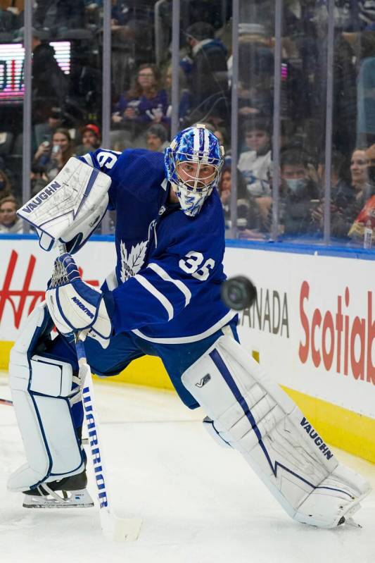 Toronto Maple Leafs goaltender Jack Campbell shoots the puck around the boards during the first ...