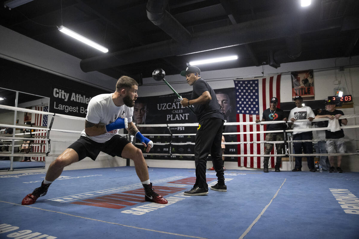 Caleb Plant, left, works on his defense with cutman Don House, at the City Boxing Club in Las V ...