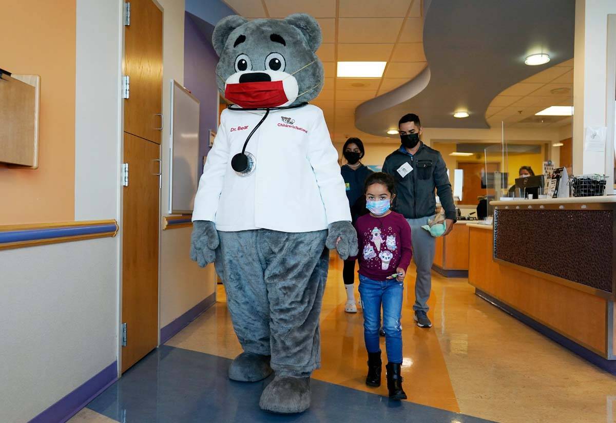 Kidney transplant patient Sophia Silvaamaya, 5, is escorted by Dr. Bear and her father, Pedro S ...